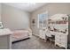 Well-lit bedroom with stylish desk, shelving, and a comfortable bed at 14634 W Wethersfield Rd, Surprise, AZ 85379