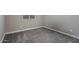 Empty bedroom space with carpet, baseboards, and small window at 14634 W Wethersfield Rd, Surprise, AZ 85379