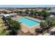 Community pool with lounge chairs surrounded by well maintained landscaping at 14634 W Wethersfield Rd, Surprise, AZ 85379