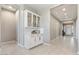 Inviting foyer with a built-in cabinet, tile flooring, and a view of the front door at 14634 W Wethersfield Rd, Surprise, AZ 85379