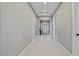 Bright hallway features neutral walls, modern lighting, and white trim, leading to various rooms in the home at 14634 W Wethersfield Rd, Surprise, AZ 85379