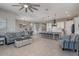 Open concept living space featuring a kitchen island with bar seating, dining area, and comfortable seating at 14634 W Wethersfield Rd, Surprise, AZ 85379