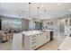 Spacious open-concept kitchen and living area with island, stainless steel appliances, and comfortable seating at 14634 W Wethersfield Rd, Surprise, AZ 85379