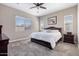 Relaxing main bedroom with large windows, plush carpet, and a king-size bed at 14634 W Wethersfield Rd, Surprise, AZ 85379