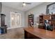 Bright office space with large desk, built-in shelving, and French doors at 14634 W Wethersfield Rd, Surprise, AZ 85379