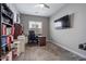 Functional home office with carpet, built-in bookshelves, and a window for natural light at 14634 W Wethersfield Rd, Surprise, AZ 85379