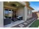 Relaxing covered patio with comfortable seating, ceiling fan, and sliding glass doors at 14634 W Wethersfield Rd, Surprise, AZ 85379
