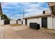 Enclosed backyard featuring white brick walls, dual access doors, and a concrete patio at 1529 E Edgemont Ave, Phoenix, AZ 85006