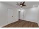 Neutral bedroom with ceiling fan, wood-look floors, closet, and white walls at 1529 E Edgemont Ave, Phoenix, AZ 85006