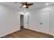 Minimalist bedroom featuring wood-look floors, a fan, and ample closet space at 1529 E Edgemont Ave, Phoenix, AZ 85006