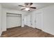 Bright bedroom with laminate flooring, ceiling fan and light fixture, and large closet at 1529 E Edgemont Ave, Phoenix, AZ 85006