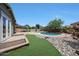 Spacious backyard featuring a pool, lush greenery, and plenty of room for outdoor activities and relaxation by the poolside at 15365 W Valentine St, Surprise, AZ 85379