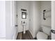 Charming powder room featuring pedestal sink, stylish mirror, and modern finishes at 15365 W Valentine St, Surprise, AZ 85379