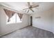Neutral bedroom with a ceiling fan, window, and plush carpet for ultimate comfort at 15365 W Valentine St, Surprise, AZ 85379