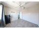 Bright bedroom with plush carpet, a ceiling fan, and a view to the upstairs hallway at 15365 W Valentine St, Surprise, AZ 85379