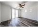 Bright bedroom featuring wood-style flooring, a ceiling fan, and a private patio door at 15365 W Valentine St, Surprise, AZ 85379