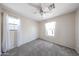 Cozy bedroom with a ceiling fan, plush carpet, and bright, natural light at 15365 W Valentine St, Surprise, AZ 85379