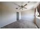 Bright bedroom featuring soft carpet, a ceiling fan, and neutral tones for a serene feel at 15365 W Valentine St, Surprise, AZ 85379