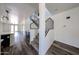 Hallway featuring hardwood floors, white walls, and view of staircase with iron railings at 15365 W Valentine St, Surprise, AZ 85379