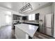 Modern kitchen featuring black cabinetry, stainless steel appliances, and quartz countertops at 15365 W Valentine St, Surprise, AZ 85379