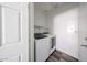 Bright laundry area equipped with modern washer and dryer units and convenient shelving at 15365 W Valentine St, Surprise, AZ 85379