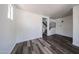 Living room featuring hardwood floors, white walls, and a view of the staircase at 15365 W Valentine St, Surprise, AZ 85379