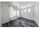 Bright living room featuring hardwood floors and large window with views of the front yard at 15365 W Valentine St, Surprise, AZ 85379