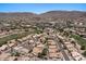 An aerial view of stunning homes with private pools, lush landscaping, solar panels and mountain views in a golf community at 15829 S 13Th Pl, Phoenix, AZ 85048