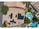 Aerial view of a home featuring solar panels, backyard pool, lounge chairs, and a well-manicured lawn at 15829 S 13Th Pl, Phoenix, AZ 85048