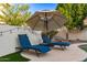 Relaxing backyard featuring lounge chairs, a shade umbrella, and tranquil privacy at 15829 S 13Th Pl, Phoenix, AZ 85048