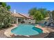 Relaxing backyard pool area featuring lounge chairs, a fire pit, lush landscaping, and a privacy fence at 15829 S 13Th Pl, Phoenix, AZ 85048