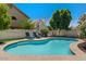 Inviting backyard pool with lounge chairs and lush landscaping providing a private and relaxing outdoor oasis at 15829 S 13Th Pl, Phoenix, AZ 85048