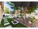 Lush backyard with an inviting pool, artificial grass, and mature landscaping at 15829 S 13Th Pl, Phoenix, AZ 85048