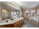 Bathroom features a large mirror over double sinks, a tub, and a gold trimmed shower at 15829 S 13Th Pl, Phoenix, AZ 85048