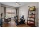 Bright bedroom featuring exercise equipment, hardwood floors, and a ceiling fan at 15829 S 13Th Pl, Phoenix, AZ 85048