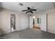 Bedroom features carpet flooring, a ceiling fan, and multiple closets and entries at 15829 S 13Th Pl, Phoenix, AZ 85048