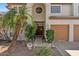 Inviting entrance with lush landscaping, desert gravel, and a solid wood front door at 15829 S 13Th Pl, Phoenix, AZ 85048