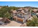 An elevated view of the tan, two-story home featuring a two-car garage and solar panels, with a pool in the backyard at 15829 S 13Th Pl, Phoenix, AZ 85048