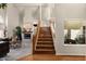 Open foyer with hardwood floors, stairs to the second level, a view into the living room, and a fireplace at 15829 S 13Th Pl, Phoenix, AZ 85048