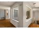 Well-lit hallway with two windows, neutral paint, tile floors, and white molding at 15829 S 13Th Pl, Phoenix, AZ 85048