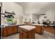 Bright kitchen featuring wood cabinets, tile countertops, and an island with views into the backyard and pool at 15829 S 13Th Pl, Phoenix, AZ 85048