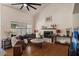 Cozy living room featuring hardwood floors, high ceilings, fireplace, and comfortable seating arrangement at 15829 S 13Th Pl, Phoenix, AZ 85048