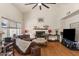 Bright living room featuring hardwood floors, high ceilings, fireplace, and comfortable seating arrangement at 15829 S 13Th Pl, Phoenix, AZ 85048