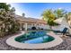 Inviting backyard pool with lush landscaping and a serene seating area at 15829 S 13Th Pl, Phoenix, AZ 85048