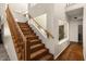 Staircase to the second level, featuring hardwood steps and landing, and a wood railing at 15829 S 13Th Pl, Phoenix, AZ 85048