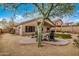 The home's backyard includes outdoor seating, patio, and mature tree at 16055 S 18Th Dr, Phoenix, AZ 85045