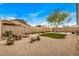 Large backyard with desert landscaping, built in seating, and synthetic grass at 16055 S 18Th Dr, Phoenix, AZ 85045