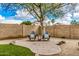 Private backyard patio featuring comfortable seating and shade from a mature desert tree at 16055 S 18Th Dr, Phoenix, AZ 85045