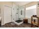 Bright bathroom features a glass-enclosed shower, neutral tile, and a window for natural light at 16055 S 18Th Dr, Phoenix, AZ 85045