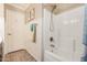 Bathroom shower and tub combo featuring clean white tile and bronze fixtures at 16055 S 18Th Dr, Phoenix, AZ 85045